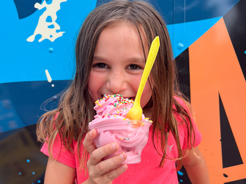 A girl enjoying Frosted Luau's Soft Serve Ice Cream