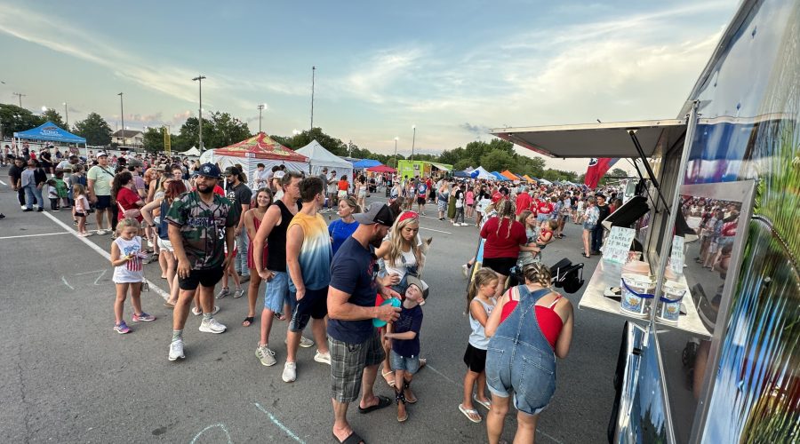 Long line of people waiting for Frosted Luau's truck for some Soft Serve Ice Cream during an event.